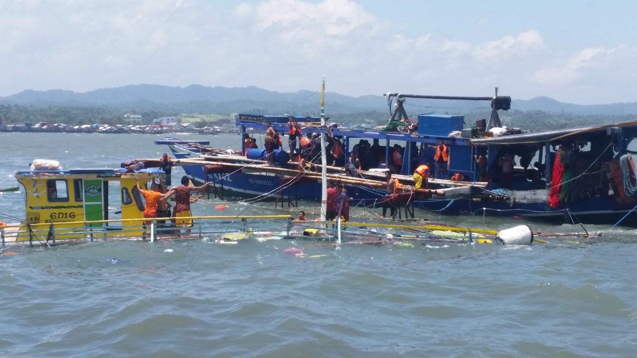 SUNKEN BOAT. The entire deck of the motor boat Mia Romcis (on the left) is submerged in water.  The passengers were brought to the rescue vessel. Photo from Philippine Coast Guard 