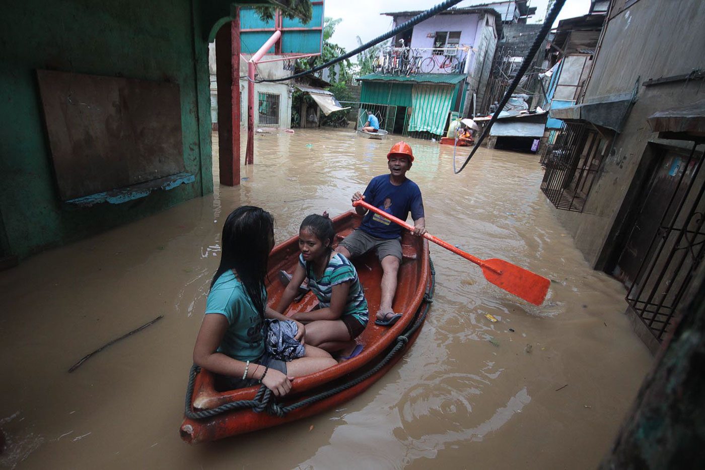 IN RIZAL. Residents of Barangay Banaba in San Mateo on a boat in waist-deep flood as they evacuate from their houses. Photo by Darren Langit/Rappler  