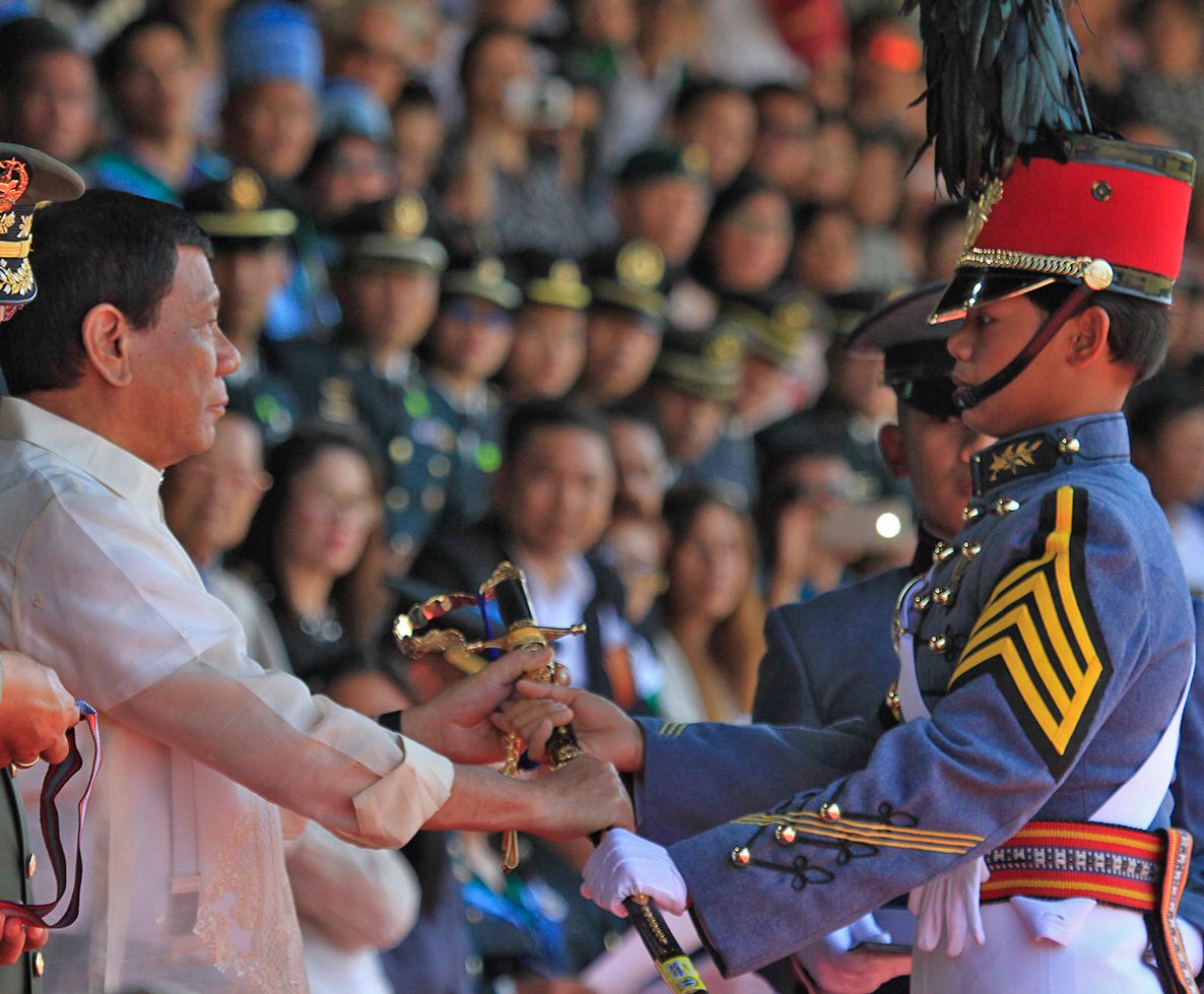 PRESIDENTIAL SABER. President Rodrigo Duterte awards the Presidential Saber to PMA Class of 2017 valedictorian Rovi Mairel Martinez. Photo by Mau Victa/Rappler   