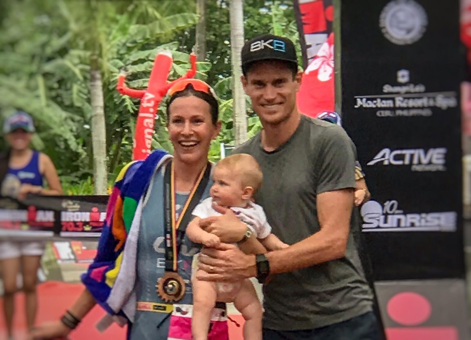 HAPPY FAMILY. Radka Kahlefeldt's husband and 7-month old daughter Ruby celebrate the women's pro champion's title at the finish line. Photo by Beatrice Go/Rappler  