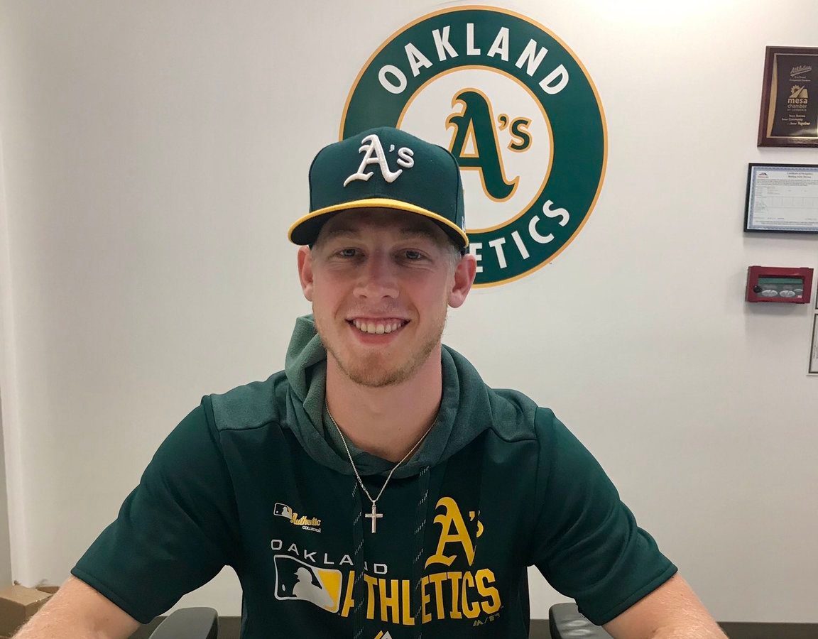 Fastball-throwing baseball fan signs for Oakland A’s