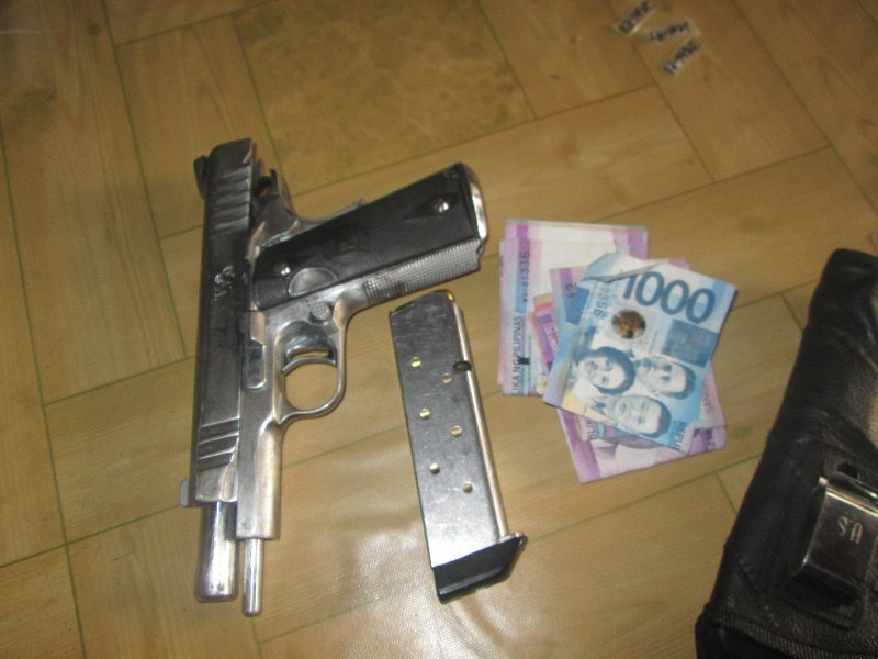 PISTOL. A .45 caliber pistol and cash confiscated from suspect Crisanto Gulang. Photo from PDEA-Zamboanga del Norte 