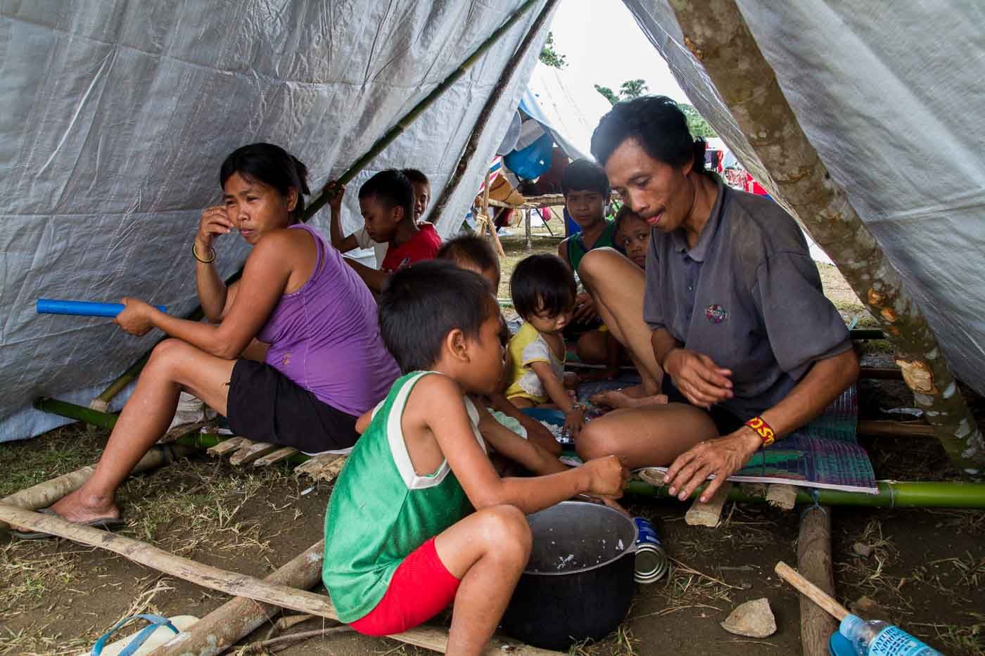 COPING. A Lumad family displaced by the conflict in Andap Valley has to wait for food provided by different aid groups and the DSWD. The Lumad are used to farming in high lands and getting their food from their own crops.   
