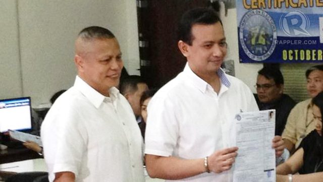 MAGDALO SUPPORT. Sen Antonio Trillanes IV shows his certificate of candidacy for senator at the Commission on Elections office in Intramuros, Manila, October 3, 2012. With Trillanes is former Marines Col Ariel Querubin, one of the leaders of the December 1989 coup. Photo by Rappler/Paterno Esmaquel II.