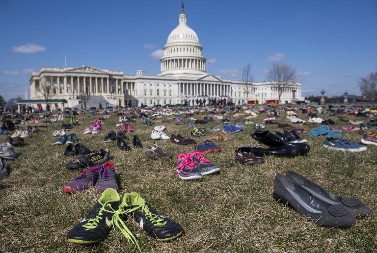 PROTEST. The lawn outside the US Capitol is covered with 7,000 pairs of empty shoes to memorialize the 7,000 children killed by gun violence since the Sandy Hook school shooting, in a display organized by global advocacy group Avaaz in Washington DC on March 13, 2018. Photo by Saul Loeb/AFP   