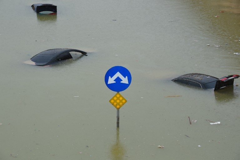 UNDERWATER. Vehicles are seen submerged in water in a flooded highway in western Riyadh following heavy rainfall across most of Saudi Arabia on November 25. Photo by Fayez Nureldine/AFP 