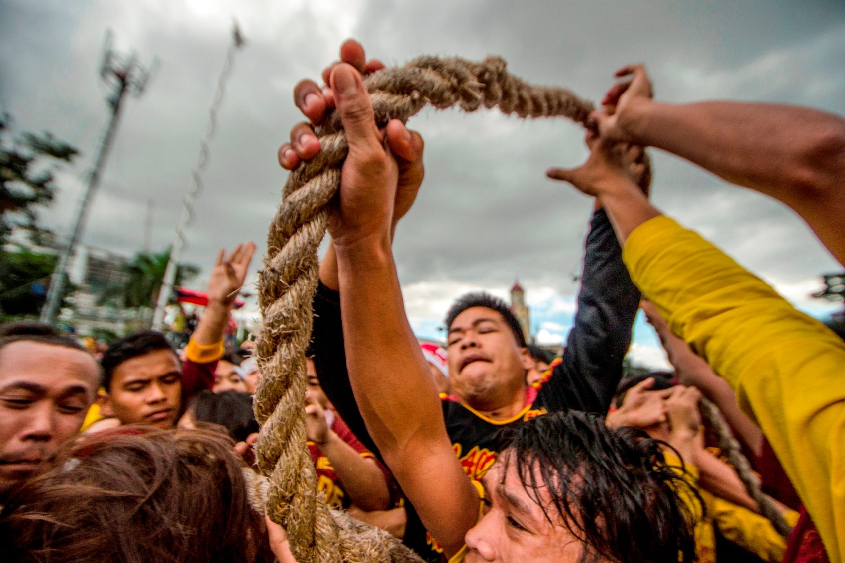 COOPERATION. The Black Nazarene rope flying after it got slack due to uneven force.  