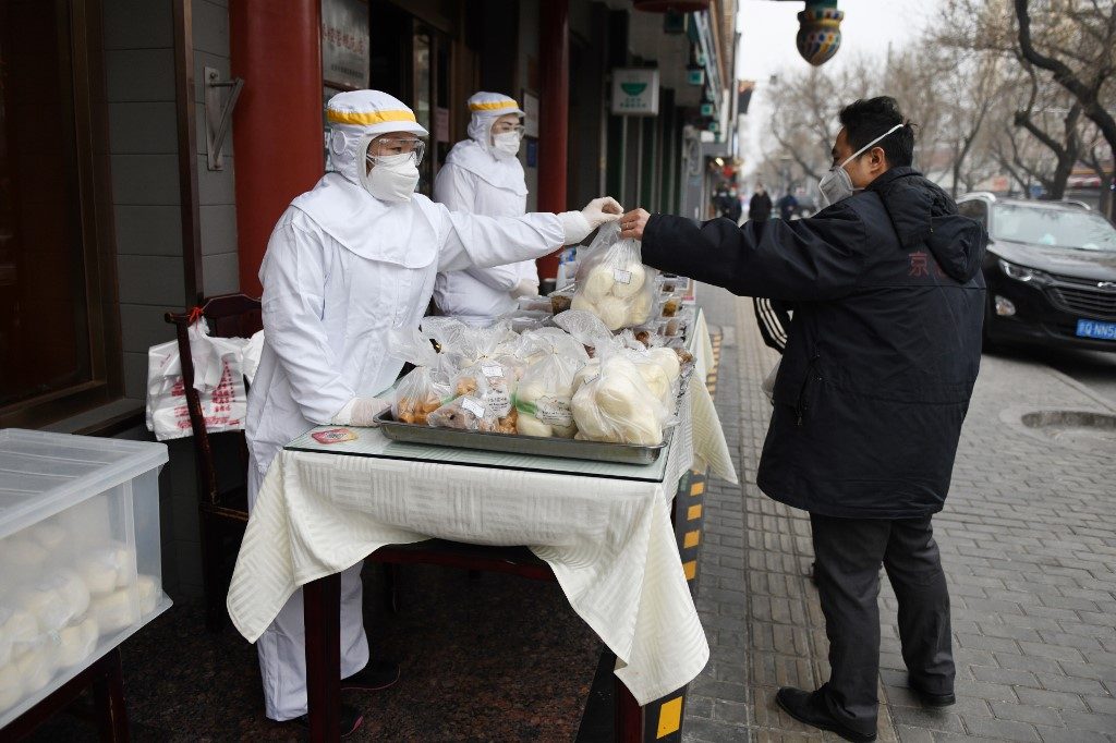 China reports 125 new virus cases, lowest number in 6 weeks