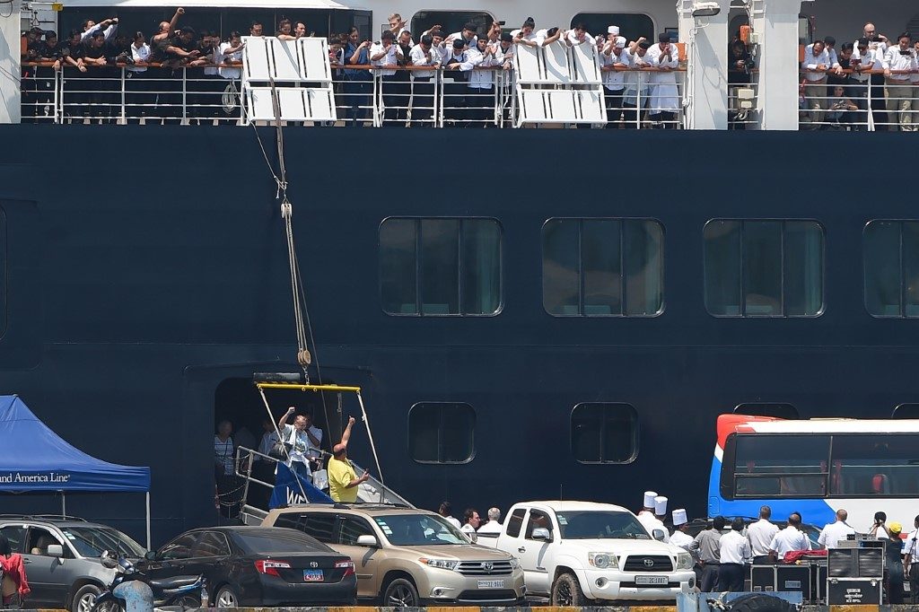 Elated passengers leave Cambodia cruise ship after virus all-clear
