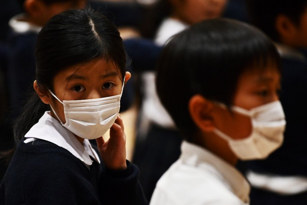 Japan politician apologizes for auctioning face masks