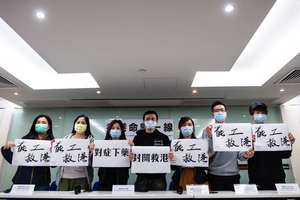 Hong Kong shuts most China crossings over virus as medics strike