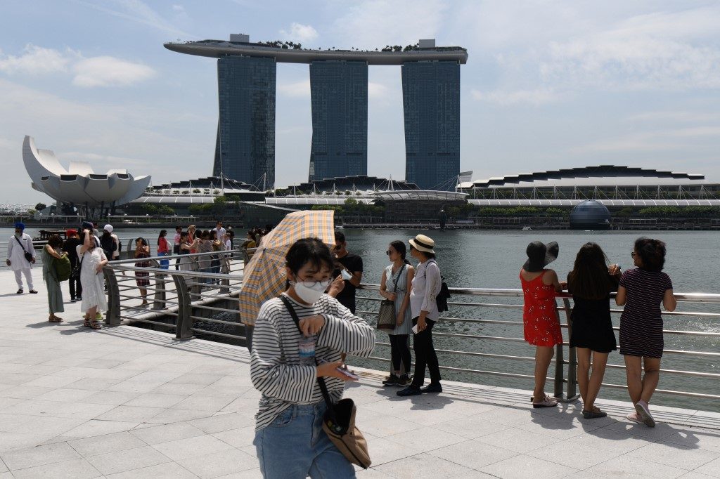 Singapore lowers growth forecast as virus hits economy