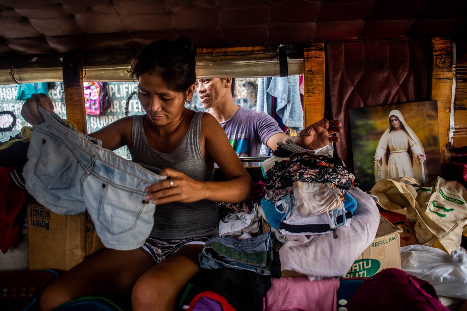 HOME. Erlin folds donated clothes inside the jeepney. When they left their house in BASECO, Julius said that the children did not have to adjust that much because they are used to small space. 