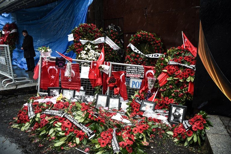 Flowers and pictures of victims have been laid in front of the Reina nightclub on January 5, 2017 in Istanbul, 4 days after a gunman killed 39 people on New Year's night. Ozan Kose/AFP 