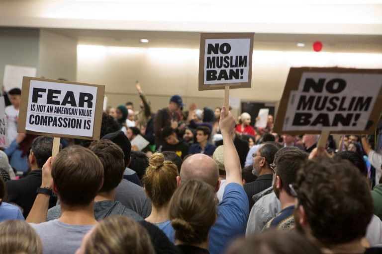'NO MUSLIM BAN' Protesters gather to denounce President Donald Trump's executive order that bans certain immigration, at Dallas-Fort Worth International Airport on January 28, 2017 in Dallas, Texas. G. Morty Ortega/Getty Images/AFP 