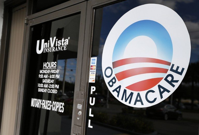 GONE SOON? An Obamacare logo is shown on the door of the UniVista Insurance agency in Miami, Florida on January 10, 2017. Rhona Wise/AFP  