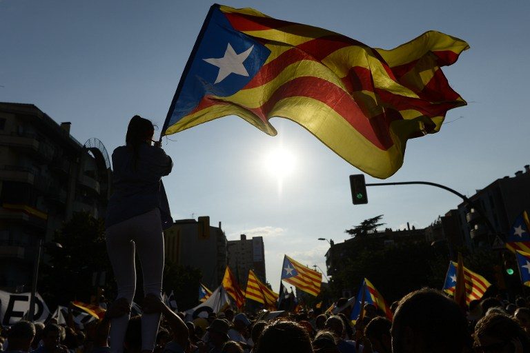 This file photo taken on September 11, 2016 shows people waving 'Estaladas' (pro-independence Catalan flags) during a pro-independence demonstration in Barcelona during the National Day of Catalonia 'Diada'. Josep Lago/AFP 