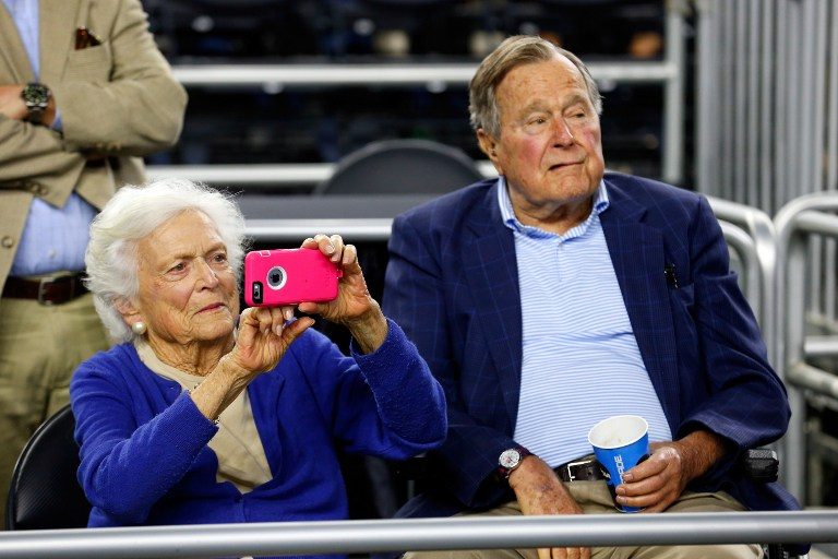 In this file photo, dormer First Lady Barbara Bush and former President George H.W. Bush look on prior to the South Regional Final of the 2015 NCAA Men's Basketball Tournament on March 29, 2015 in Houston, Texas. Tom Pennington/Getty Images/AFP 