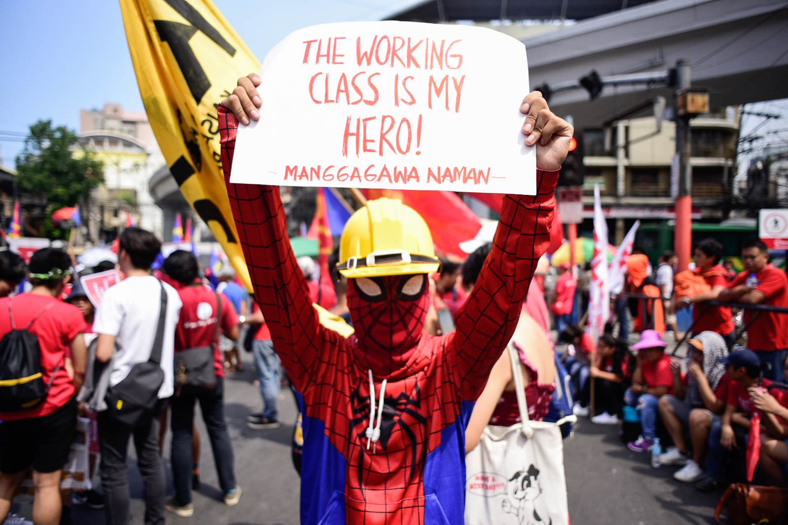 WORKING CLASS HERO. A protester in a Spider-Man suit holds a poster during the Labor Day protest in Mendiola. Photo by Rob Reyes/Rappler  