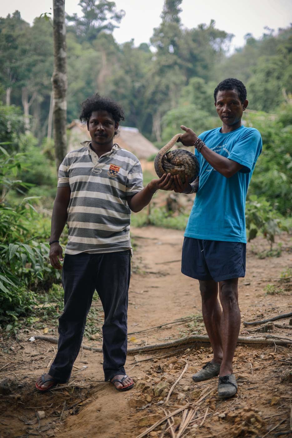INDIGENOUS HUNTERS. Two hunters from the indigenous Temiar community in Peninsular Malaysia pose with a pangolin they had just caught the day before. The pangolin was later released. Photo by Puah Sze Ning/R.AGE 