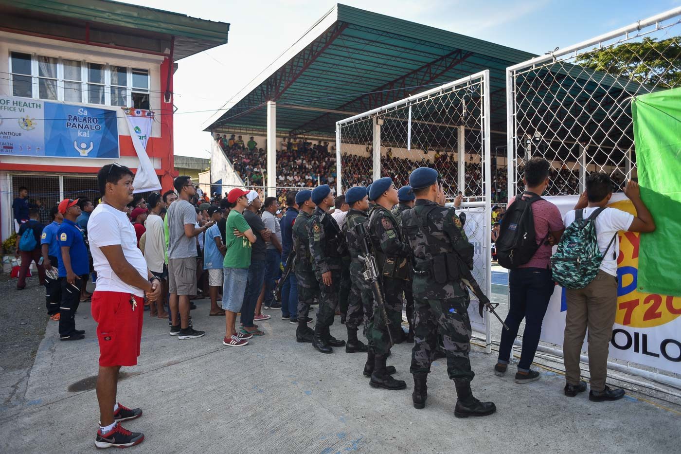 SECURED. Members of the Antique Police watch a basketball game between Western Visayas and Central Luzon at the Binirayan Sports Complex. Photo by LeAnne Jazul/Rappler  