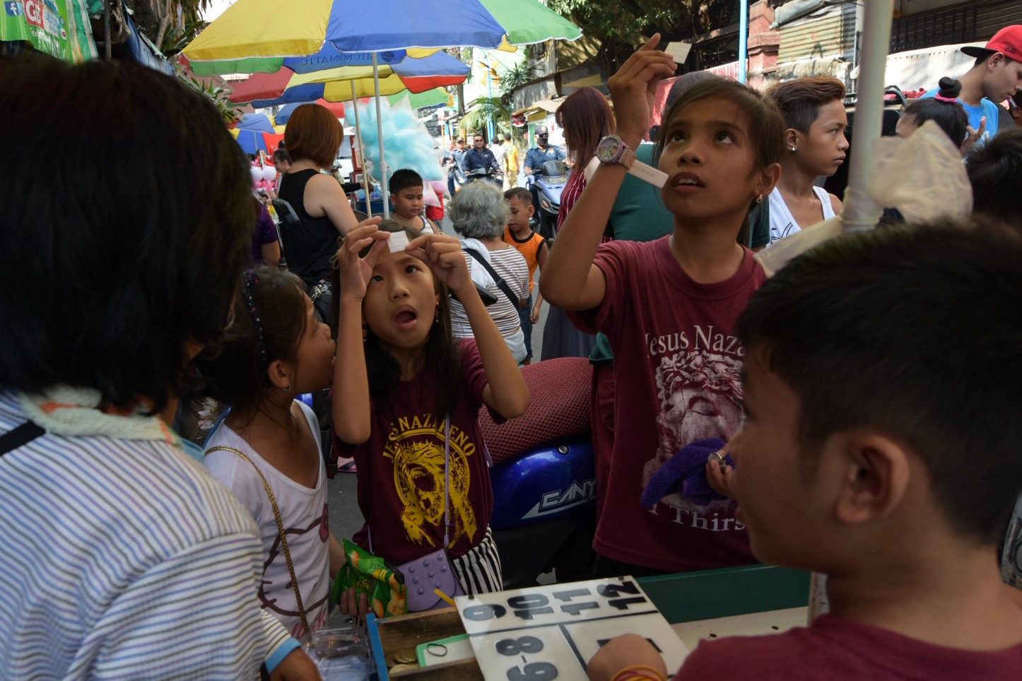 Kids try their luck to bring home a pet for a peso. 