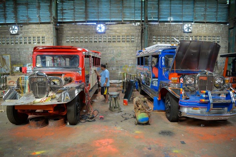 DYING ART. Vic Capuno, 52-year-old jeepney artist is shown painting in one of the jeepneys at a workshop in San Pablo, Laguna. Photo by Ted Aljibe/AFP 