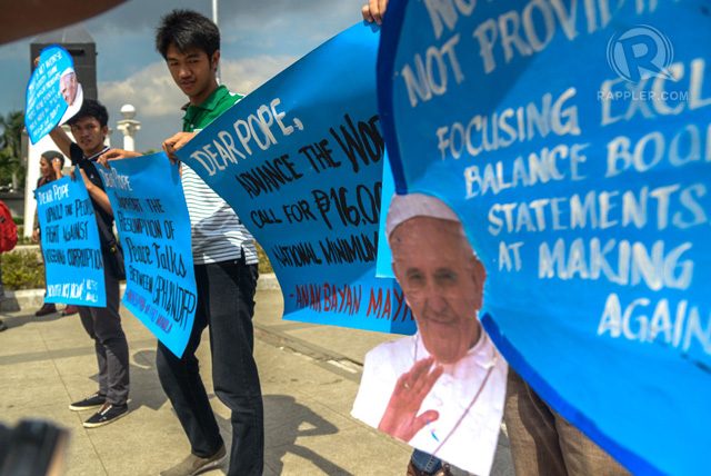 Two days before the arrival of Pope Francis in the Philippines, youth members of ANAKBAYAN protests in front of Quirino Grandstand Tuesday. Photo by Jansen Romero/Rappler