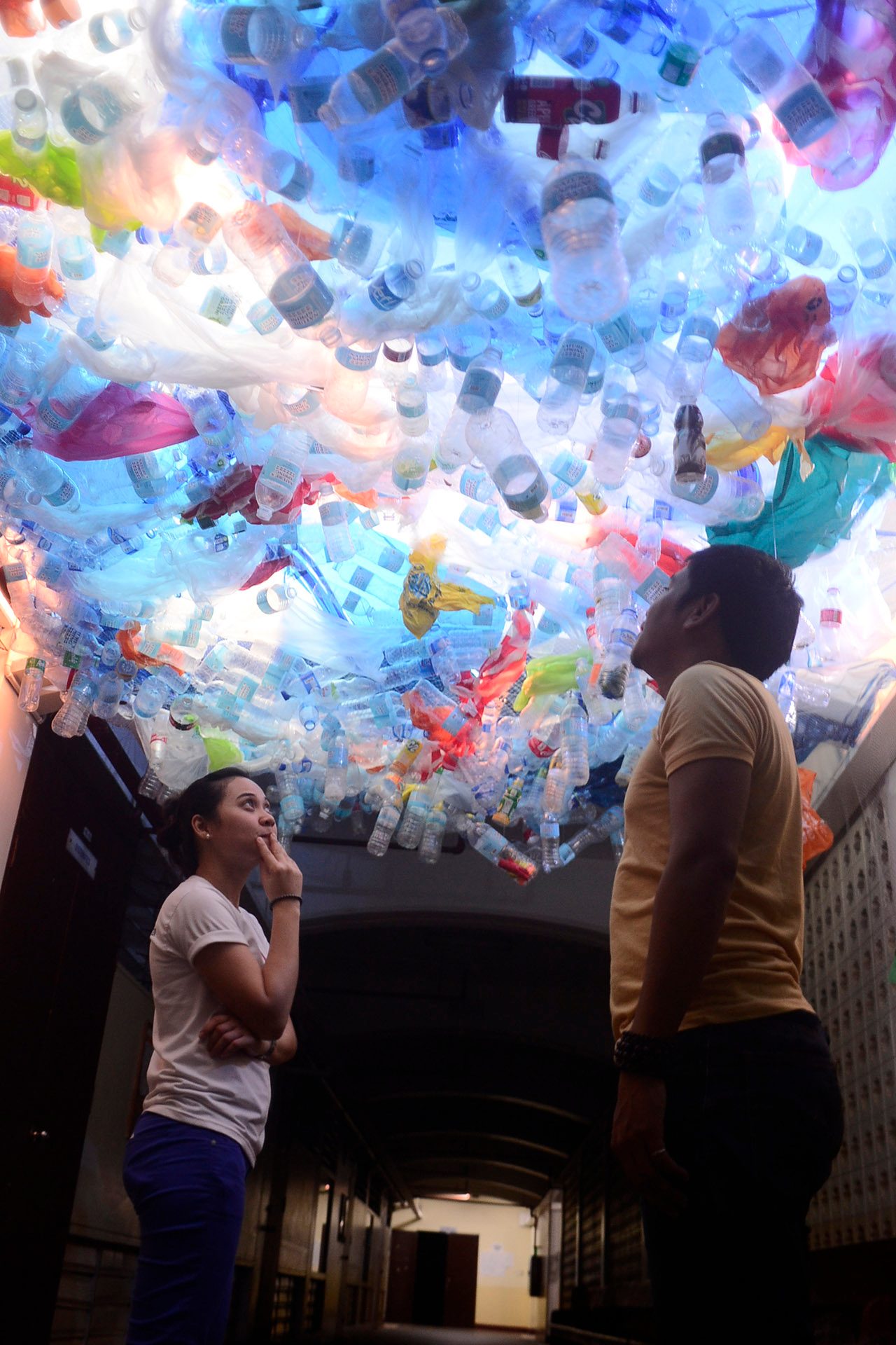 PERSPECTIVE. Plastic bottles, bags, and other single-use plastics hang from the XU Science Center's ceiling to simulate the suffocation of marine life. Photo from McKeough Marine Center 