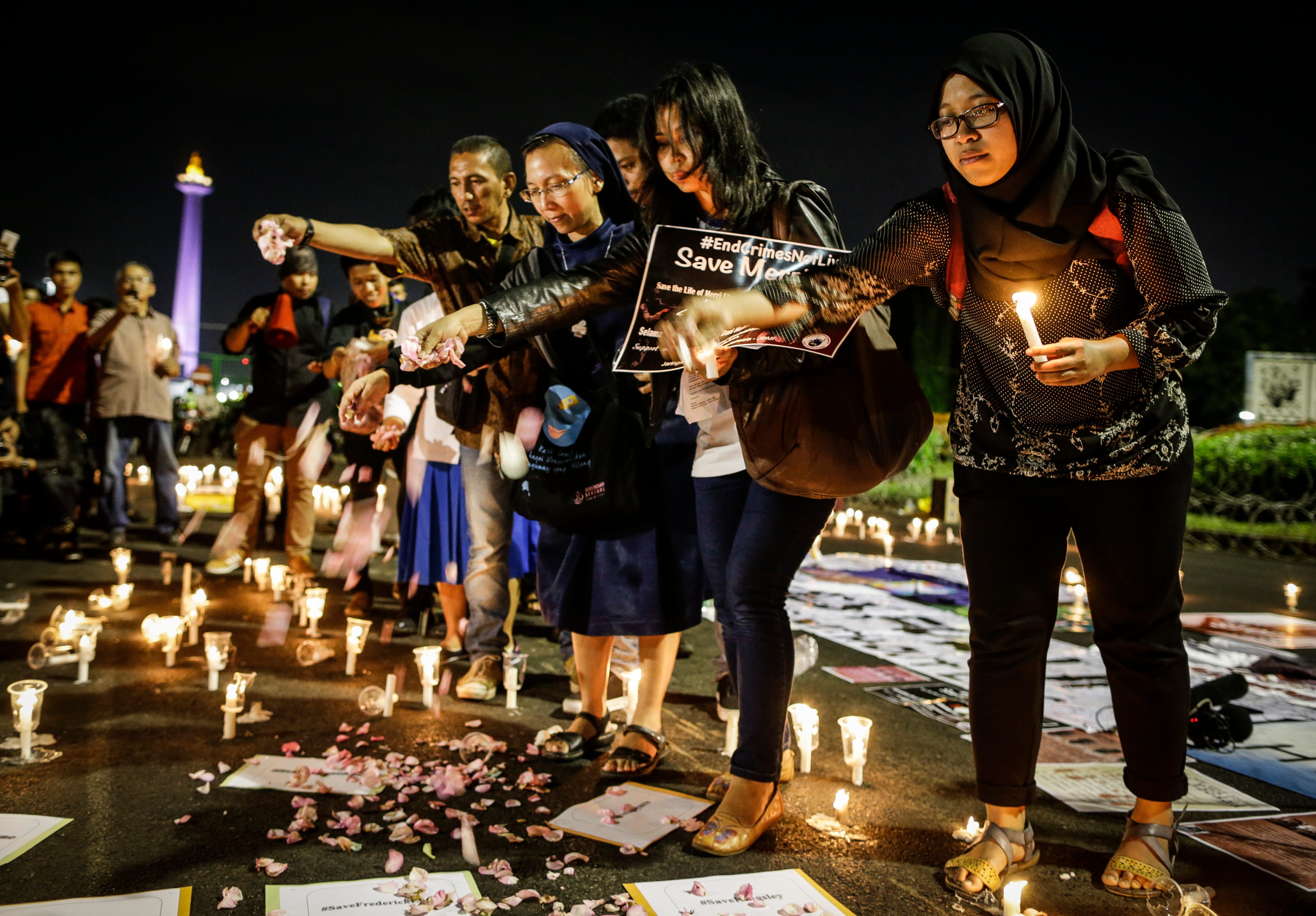 DEATH PENALTY. Indonesian activists throw flower petals during a candlelight protest against death penalty executions, outside the presidential palace in Jakarta, Indonesia, 28 July 2016. EPA 