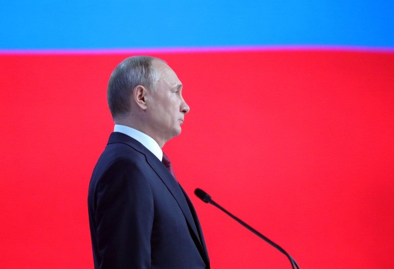 EXTENDED RULE? In this file photo, Russian President Vladimir Putin, officials, and other attendees listen to the national anthem at the end of Vladimir Putin's annual state of the nation address in Moscow on February 20, 2019. File photo by Mikhail Klimentyev/Sputnik/AFP 