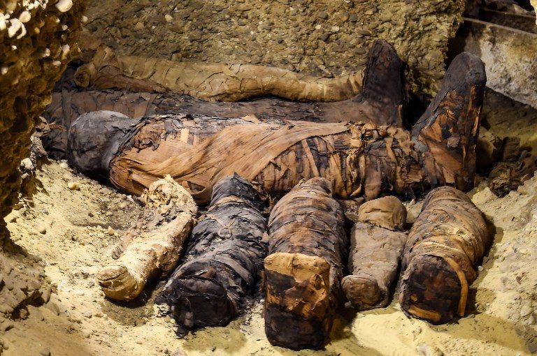 BURIAL CHAMBER. Newly discovered mummies wrapped in linen are found in burial chambers dating to the Ptolemaic era (323-30 BC) at the necropolis of Tuna el-Gebel in Egypt's southern Minya province on February 2, 2019. Photo by Mohamed El-Shahed/AFP  