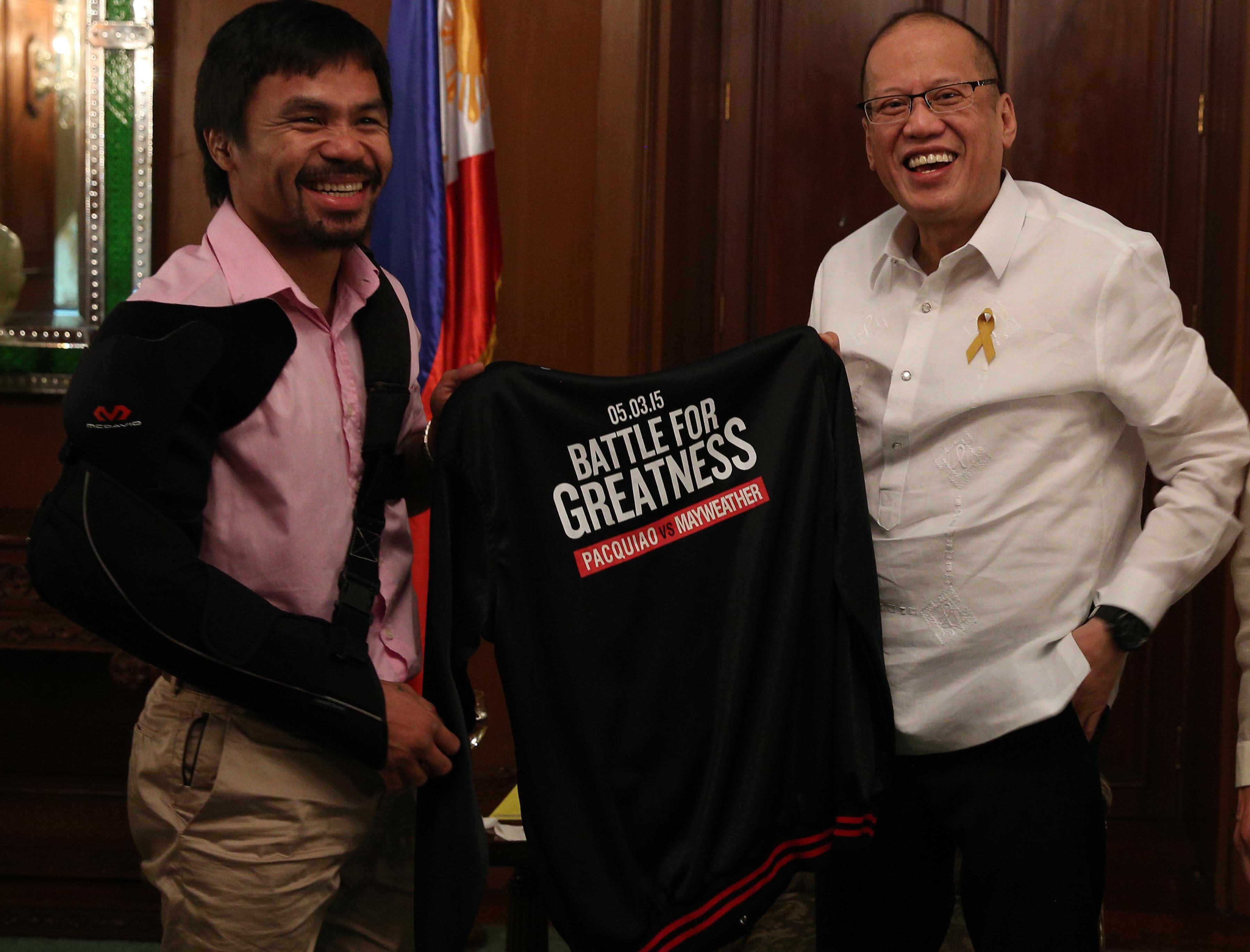 President Benigno S. Aquino III receives a black jacket from boxer Manny Pacquiao during the courtesy call at the Music Room of the Malacañan Palace on Wednesday. Ryan Lim/ Malacañang Photo Bureau 