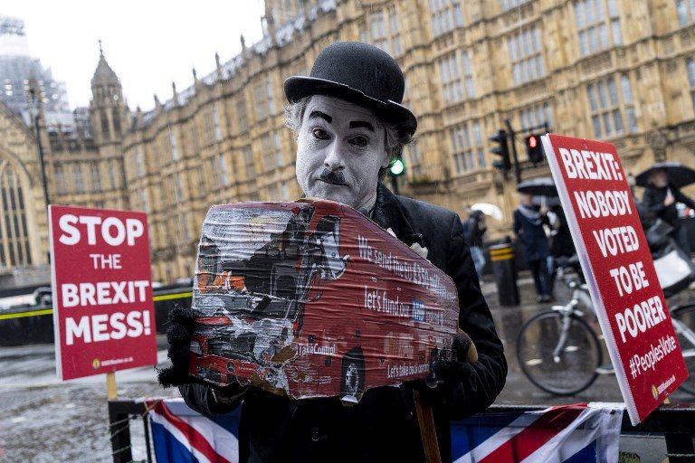 ANTI-BREXIT. An activist holds a placard as he demonstrates outside the Houses of Parliament in London on March 12, 2019, ahead of the debate leading to the second meaningful vote on the government's Brexit deal. Photo by Niklas Halle'n/AFP  