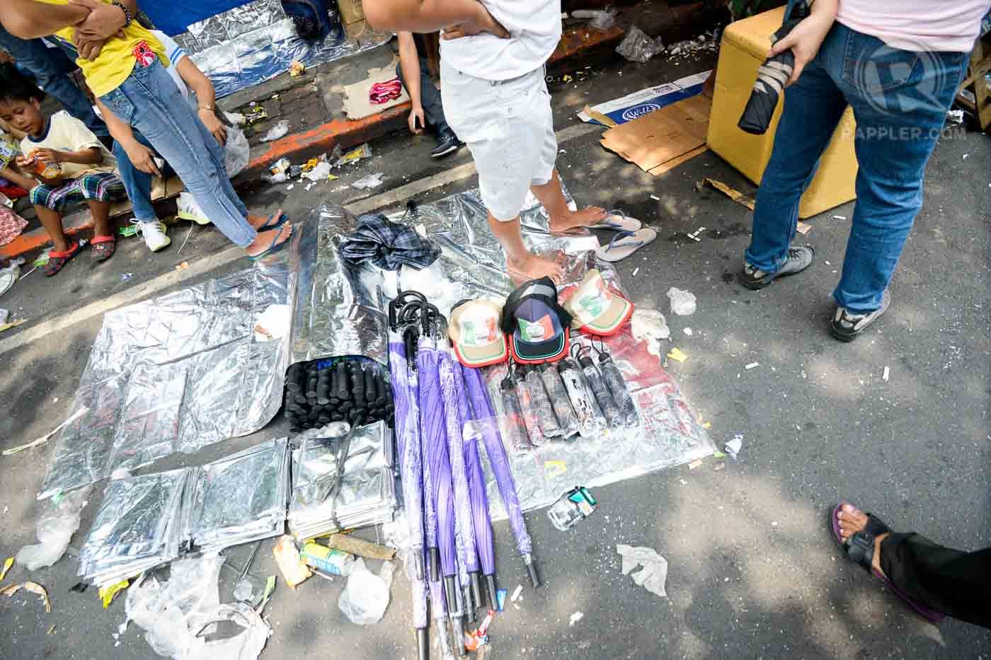 INC merchandise along the streets of Padre Faura—Sleeping mats, caps and umbrellas. Photo by LeAnne Jazul/Rappler