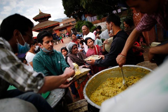 OUTDOOR KITCHEN. People line up to receive food given to displaced people affected by the earthquake offered by a Hare Krishna group outside Durbar Square in Bhaktapur, Kathmandu, Nepal, April 29, 2015. Diego Azubel/EPA 