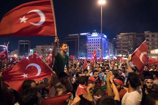 CELEBRATION. People shout slogans and hold Turkish national flags during a demonstration against the failed Army coup attempt at Taksim Square in Istanbul, Turkey on July 17, 2016. Photo by Marius Becker/EPA    