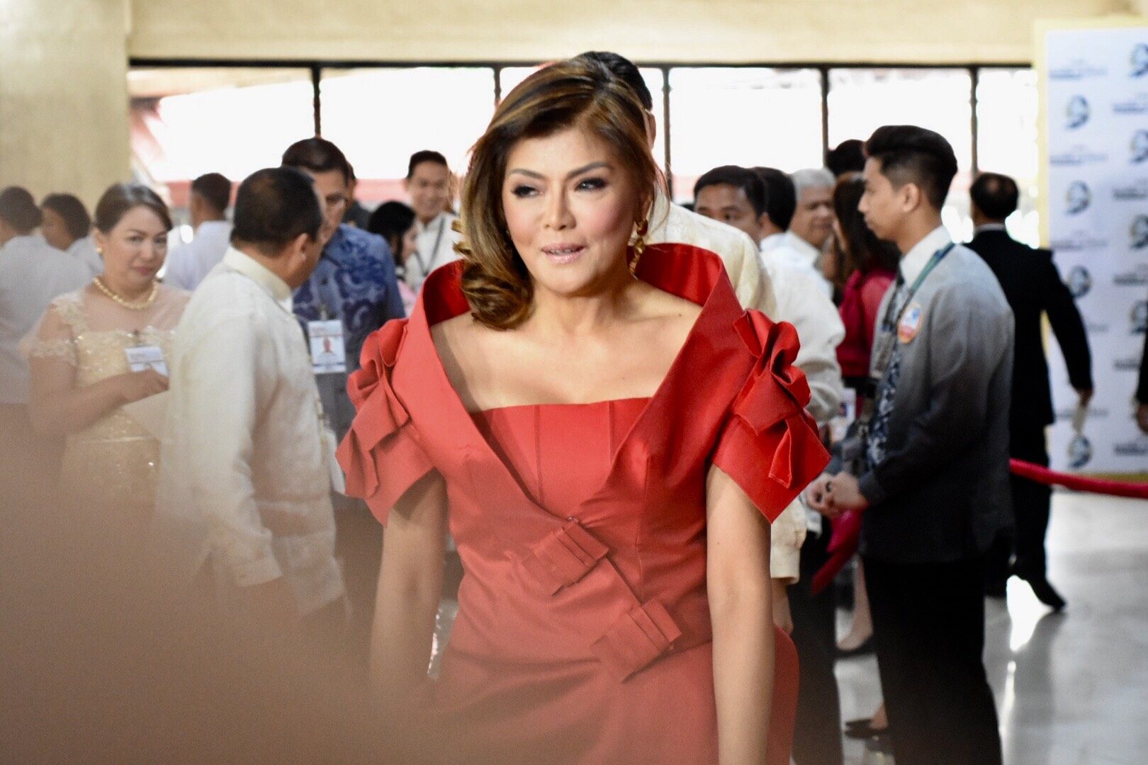 LADY IN RED. Ilocos Norte Governor Imee Marocs walks down the red carpet at the Batasang Pambansa before President Rodrigo Duterte's 3rd State of the Nation Address. Photo by Angie de Silva/Rappler      