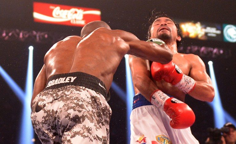 Timothy Bradley connects against Manny Pacquiao during their WBO World Welterweight Championship title match at the MGM Grand Arena. Photo by Joe Klamar/AFP