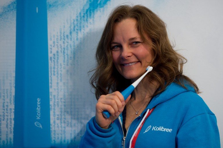 CONNECTED EVERYTHING. A hostess poses with a toothbrush "ara" by Kolibree's company during the Mobile World Congress on the last day of the MWC in Barcelona, on March 2, 2017. Photo by Josep Lago/AFP 