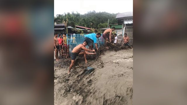 MUDDY TASK. A group of men digs hard mud to clear an area affected by the lahar flow in Barangay Buso-Buso in Laurel, Batangas. Photo from the Sangguniang Kabataan ng Buso-Buso Facebook page. 
