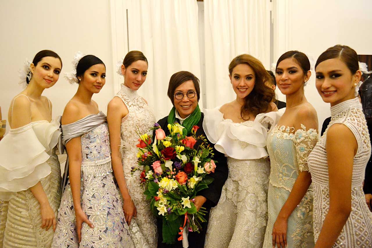 BLUSHING BRIDES. Renee Salud poses with his models wearing neo-ethnic bridal gowns.