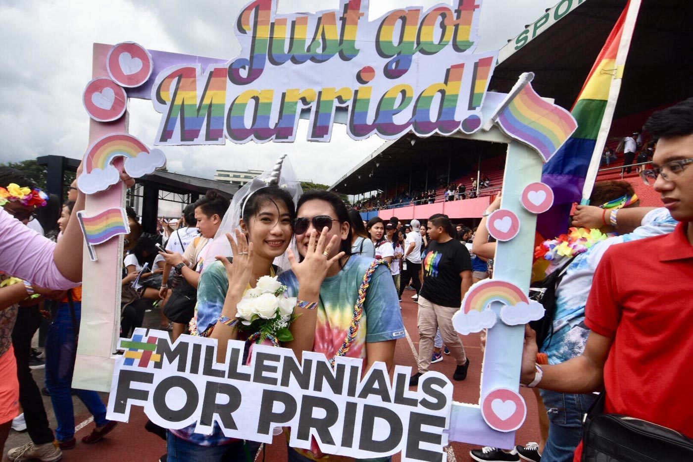 HAPPY EVER AFTER. A gay couple proudly displays wedding rings after tying the knot during the Metro Manila Pride March at the Marikina Sports complex on June 30, 2018. Photo by Angie de Silva/Rappler  