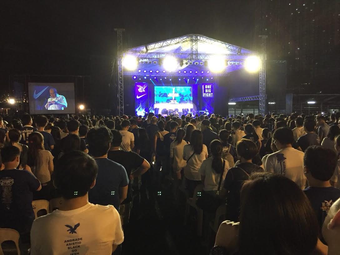 OPENING. Fr Kit Bautista SJ leads the Ateneo community in prayer during the bonfire program at the Ateneo Grade School grounds.
  
