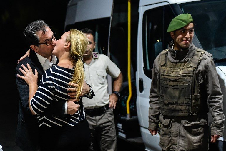 FREEDOM. Kadri Gursel kisses his wife after his release from Silivri prison in Istanbul on September 26, 2017, following a Turkish court order to free the columnist and editorial director of Turkey's opposition newspaper, Cumhuriyet. Photo by Yasin Akgul/AFP  