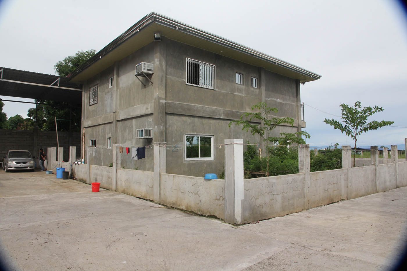 The two-storey house equipped with air-conditioning units beside the warehouse. Photo by Jun A. Malig 