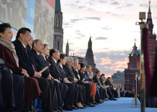 VIP ROW. Russian President Vladimir Putin (3-L) and Chinese President Xi Jinping (2- L) and his wife Peng Liyuan (L) and other guests attend a concert called 'The Roads of Great Victory' in Red Square in Moscow, Russia, 09 May 2015. Alexei Drugnyn/RIA Novosti/Kremlin pool/EPA 