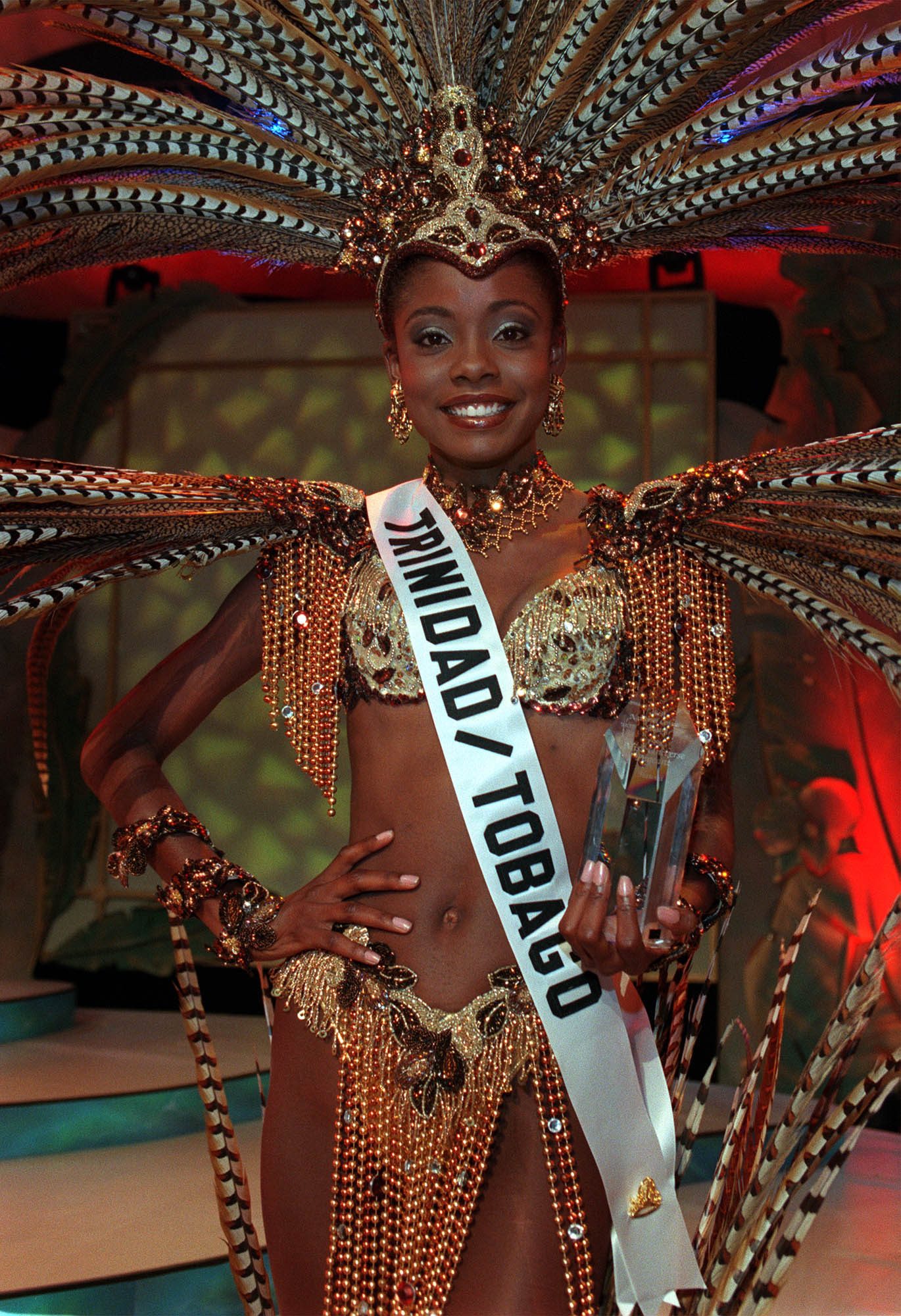 Wendy Fitzwilliam, MISS TRINIDAD & TOBAGO 1998, wins Best in National Costume Award May 7, 1998 from Honolulu, Hawaii chosen by a panel of Hawaiian based judges. Fitzwilliam said the costume, entitled "Freedom" , represents the spirit of her people and a cry of hope. The prize includes $1,000 cash and commemorative Hoya Crystal Trophy.  Photo from the Miss Universe Organization 