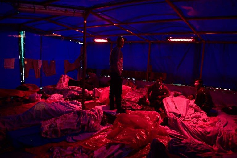 RESCUED AT SEA. Migrants wake up aboard the MV Aquarius, a rescue vessel chartered by SOS-Mediterranee and Doctors Without Borders (MSF Medecins Sans Frontieres), near the port of Catania, Sicily, on May 10, 2018. Photo by Louisa Gouliamaki/AFP   