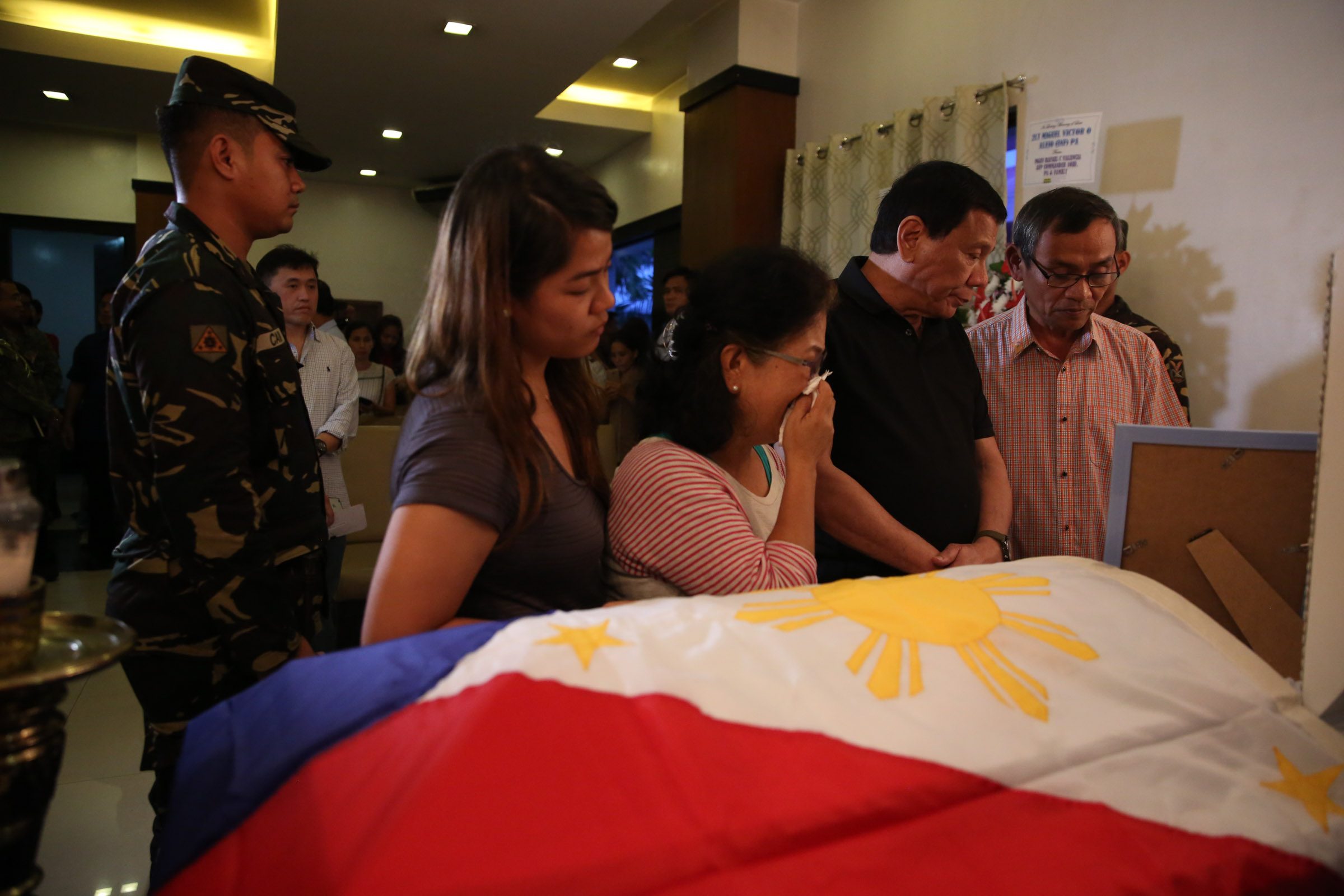 SOFT SPOT. President Rodrigo Duterte condoles with Norman and Nelia Alejo, parents of slain soldier Second Lieutenant Miguel Victor Alejo who was killed in an encounter with communist rebels in Manay, Davao Oriental last February 1,2017. Photo by Toto Lozano/Presidential Photo 